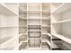 Spacious walk-in closet with custom shelving, drawers, and ample storage at 801 Dragons Eye Dr, Henderson, NV 89012