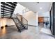 Modern home entrance featuring an open staircase, high ceilings, and sleek design elements at 801 Dragons Eye Dr, Henderson, NV 89012