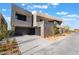 Modern home exterior with architectural design, desert landscaping, and a private two-car garage at 801 Dragons Eye Dr, Henderson, NV 89012