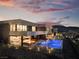 Beautiful modern home with a pool, outdoor seating, and scenic views, ideal for relaxing and entertaining in style at 801 Dragons Eye Dr, Henderson, NV 89012