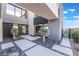 Modern home featuring a courtyard with pavers, gravel, desert landscaping, and sleek architectural details at 801 Dragons Eye Dr, Henderson, NV 89012