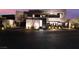 Illuminated modern home showcasing its architectural design and lush landscaping at dusk at 801 Dragons Eye Dr, Henderson, NV 89012