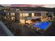 Stunning exterior view of a modern home with a pool and outdoor living area, perfect for entertaining and relaxing at 801 Dragons Eye Dr, Henderson, NV 89012