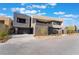 Chic modern home with architectural flair, a well-maintained driveway, and beautiful landscaping for sophisticated living at 801 Dragons Eye Dr, Henderson, NV 89012