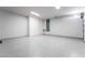 Spacious garage with epoxy flooring, storage cabinets, and ample lighting at 801 Dragons Eye Dr, Henderson, NV 89012