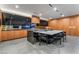 A modern kitchen featuring black cabinets, wood panels, and a large kitchen island at 801 Dragons Eye Dr, Henderson, NV 89012