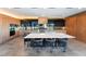 Modern kitchen showcasing a large island with seating, wood cabinets, and contemporary appliances at 801 Dragons Eye Dr, Henderson, NV 89012