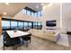 Bright living room with floor-to-ceiling windows and fireplace; ideal for entertaining at 801 Dragons Eye Dr, Henderson, NV 89012