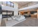 Living room with high ceilings, a stylish sofa, and views into the kitchen and exterior at 801 Dragons Eye Dr, Henderson, NV 89012