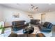 Modern living room with stylish seating, sleek black accents, and decorative art, creating an inviting space for relaxation at 801 Dragons Eye Dr, Henderson, NV 89012