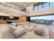 Open-concept living room with modern finishes and expansive sliding doors to an outdoor patio with a stunning view at 801 Dragons Eye Dr, Henderson, NV 89012