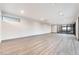 Bright living room with wood floors, recessed lighting, and sliding glass doors opening to a balcony at 801 Dragons Eye Dr, Henderson, NV 89012