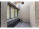 Modern outdoor shower featuring gray tile flooring, square rainfall shower head, and a bench at 801 Dragons Eye Dr, Henderson, NV 89012