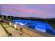 Stunning infinity pool with lounge chairs offering breathtaking views of the city skyline at twilight at 801 Dragons Eye Dr, Henderson, NV 89012