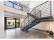 Modern home staircase featuring steel railings and tile flooring leading to a bright, open living space at 801 Dragons Eye Dr, Henderson, NV 89012