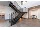 Modern staircase with metal railings, open design, and stylish lighting at 801 Dragons Eye Dr, Henderson, NV 89012