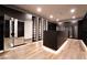 Spacious walk-in closet with custom shelving, drawers, mirrored doors, and illuminated base for a luxury feel at 801 Dragons Eye Dr, Henderson, NV 89012