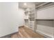 Organized walk-in closet with built-in shelving, drawers, and hanging rods at 801 Dragons Eye Dr, Henderson, NV 89012