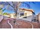 A cozy backyard with decorative rock, mature landscaping and privacy wall for relaxation at 8024 Hurricane Cove Ct, Las Vegas, NV 89129