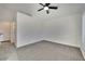 Bright bedroom features neutral carpet, ceiling fan, and white walls with modern design at 8024 Hurricane Cove Ct, Las Vegas, NV 89129