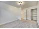 Bright bedroom features neutral carpeting, white trim, and closet with shelving at 8024 Hurricane Cove Ct, Las Vegas, NV 89129