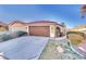 Single-story home with tile roof, tidy front yard, and a two-car garage at 8024 Hurricane Cove Ct, Las Vegas, NV 89129