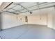 Spacious two-car garage is painted with epoxy flooring and has overhead storage at 8024 Hurricane Cove Ct, Las Vegas, NV 89129