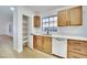 Bright kitchen features white countertops, and pantry with shelving for storage at 8024 Hurricane Cove Ct, Las Vegas, NV 89129