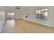 Bright living area featuring light wood flooring, neutral walls, and a ceiling fan at 8024 Hurricane Cove Ct, Las Vegas, NV 89129