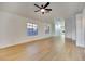 Living room featuring wood flooring, neutral walls, ceiling fan, and natural light at 8024 Hurricane Cove Ct, Las Vegas, NV 89129