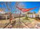 Backyard features a shade sail, a small storage shed, plants and a brick wall at 8229 Willeta Ave, Las Vegas, NV 89145