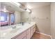 Bright bathroom featuring a double sink vanity and a large mirror at 8229 Willeta Ave, Las Vegas, NV 89145