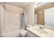 Bathroom with a shower and tub combination, single sink and decorative mirror at 8229 Willeta Ave, Las Vegas, NV 89145