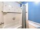 The bathroom features a shower and bathtub combination with blue accents at 8229 Willeta Ave, Las Vegas, NV 89145