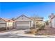 Charming single-Gathering home featuring a two-car garage and low-maintenance desert landscaping in the front yard at 8229 Willeta Ave, Las Vegas, NV 89145