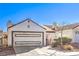 Charming single-Gathering home featuring a two-car garage and low-maintenance desert landscaping in the front yard at 8229 Willeta Ave, Las Vegas, NV 89145