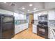 Bright kitchen features white cabinets, stainless appliances, and mosaic tile backsplash at 8229 Willeta Ave, Las Vegas, NV 89145