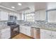 Traditional-style kitchen featuring stainless steel appliances and beautiful granite countertops at 8229 Willeta Ave, Las Vegas, NV 89145