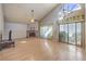 Spacious living room with a brick fireplace, laminate floors, and natural light at 8229 Willeta Ave, Las Vegas, NV 89145