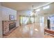 Spacious living room with a brick fireplace, laminate floors, and natural light at 8229 Willeta Ave, Las Vegas, NV 89145