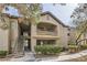 Apartment building with balconies, stairs, and well-maintained landscaping on a sunny day at 8250 N Grand Canyon Dr # 2102, Las Vegas, NV 89166