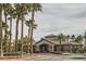 Inviting clubhouse entrance with desert landscaping and palm trees on a sunny day at 8250 N Grand Canyon Dr # 2102, Las Vegas, NV 89166