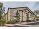 View of the exterior of a multi-unit residential building with mature trees at 8250 N Grand Canyon Dr # 2102, Las Vegas, NV 89166