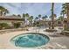 Relaxing community hot tub surrounded by lush landscaping, palm trees and lounge chairs at 8250 N Grand Canyon Dr # 2102, Las Vegas, NV 89166