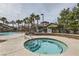 Outdoor hot tub with a view of a community pool and lush landscaping and palm trees at 8250 N Grand Canyon Dr # 2102, Las Vegas, NV 89166