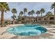 Community swimming pool with multiple buildings, palm trees, and lounge chairs for relaxation at 8250 N Grand Canyon Dr # 2102, Las Vegas, NV 89166