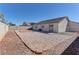 Backyard featuring a low-maintenance gravel design with an outer brick border at 832 Vineyard Vine Way, North Las Vegas, NV 89032