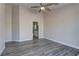 Bedroom featuring a ceiling fan, wood-look flooring, and ensuite bathroom at 832 Vineyard Vine Way, North Las Vegas, NV 89032