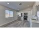 Bright kitchen with stainless steel appliances, white cabinetry, and gray wood-look flooring at 832 Vineyard Vine Way, North Las Vegas, NV 89032