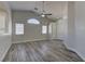 Bright living area featuring vaulted ceilings, modern floors, and a ceiling fan at 832 Vineyard Vine Way, North Las Vegas, NV 89032